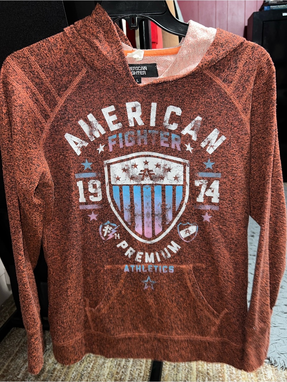American Fighter Rust Orange Hoodie with Blue & White Shield Graphic